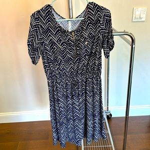Navy blue dress with polkadot style. Zipper in chest area and buttons.